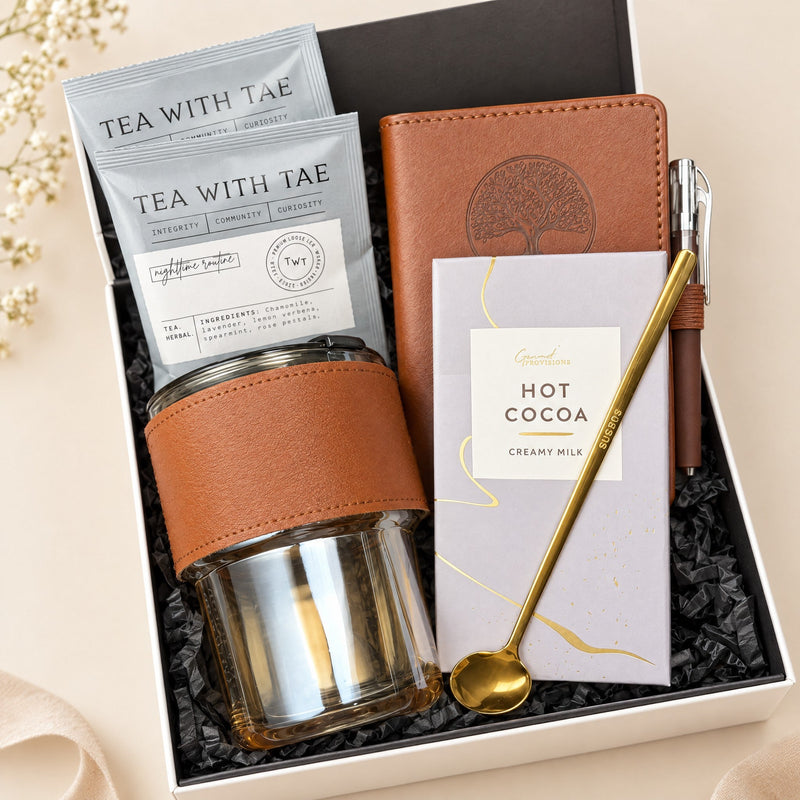 Corporate gift box for employees with tea, hot cocoa, leather journal, pen and glass cup